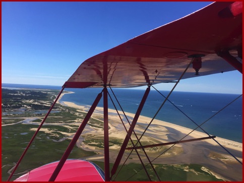 biplane over beaches